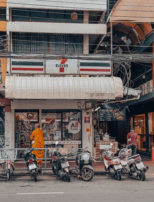 Street-level retail in Thailand with local transport, showcasing global service reach